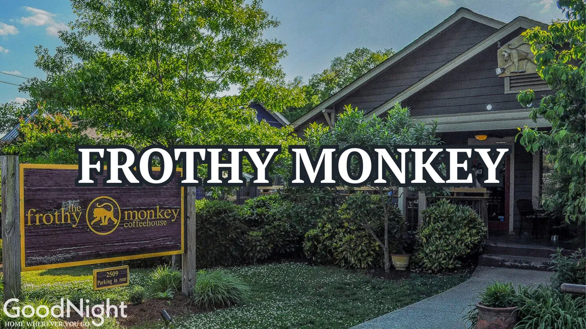 The exterior of Frothy Monkey, a beloved local coffee shop, surrounded by greenery and featuring inviting outdoor seating. The space looks relaxed and sociable, encouraging community interactions and casual gatherings.